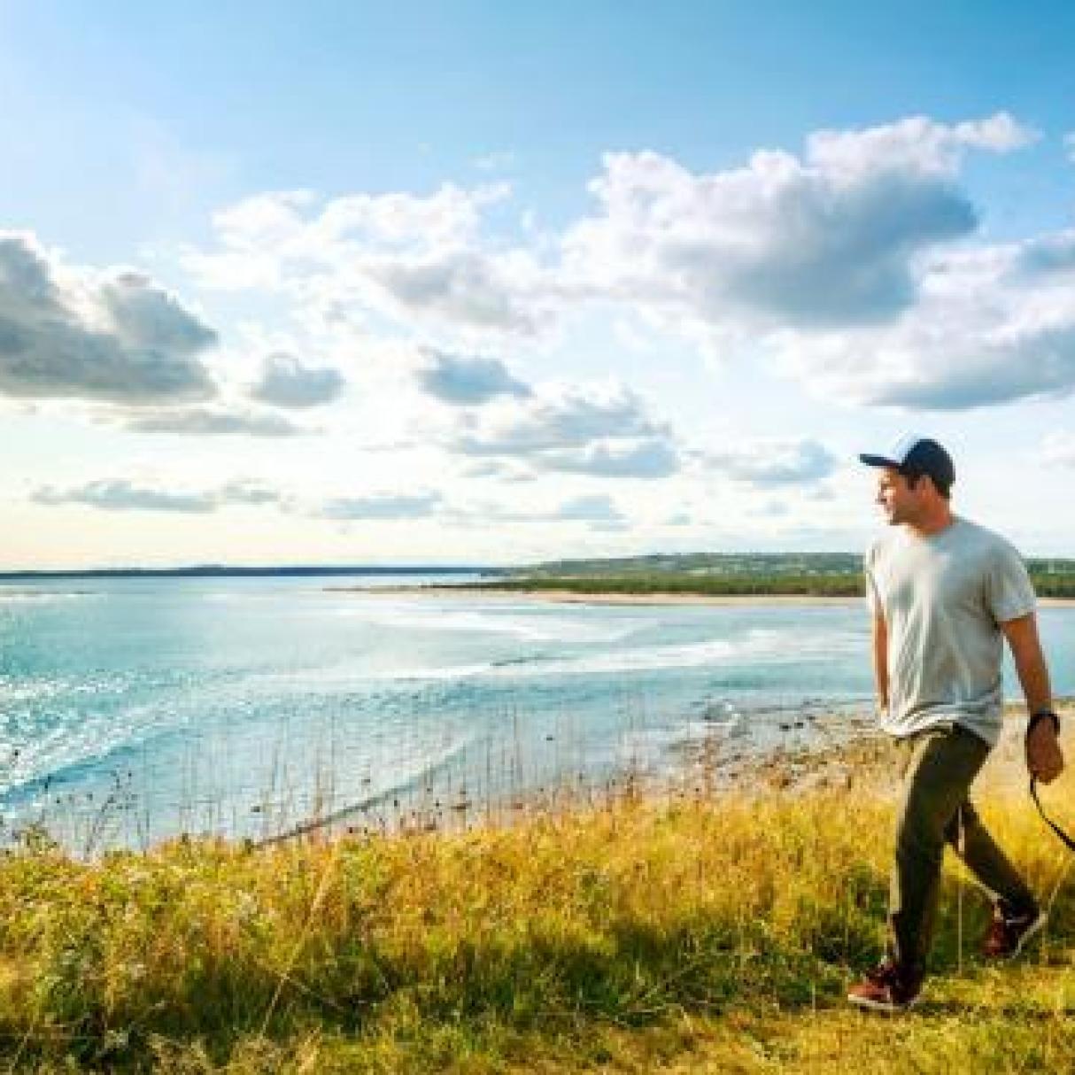 A man walks his dog on the Eastern Shore in Nova Scotia